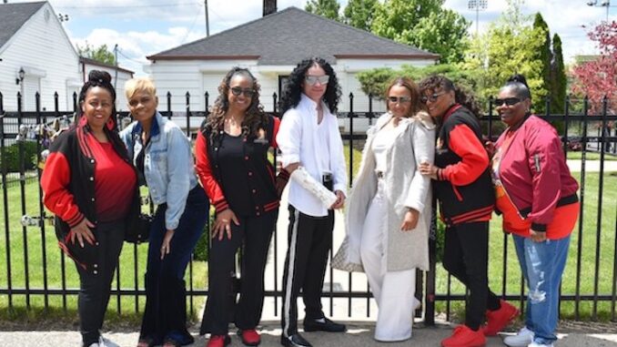 dsc_0570 The Jacksons lady in front of home Featured